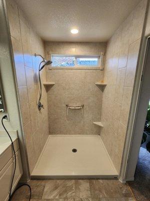 Almost complete. We had the original shower area (pan) widened by 8" and what a difference!