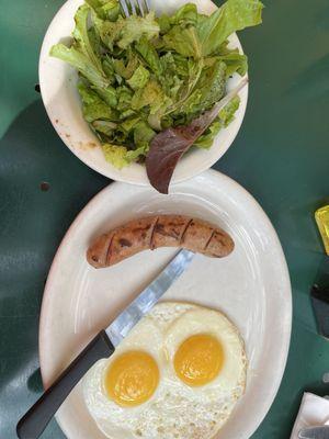 2 eggs, 1 garlic Apple Sausage and a bowl of leaves they call a salad.