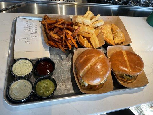 Puerto Rican burger, classic burger, yuca fries, sweet potato fries, and two empanadas (one beef and one cheese). All good!