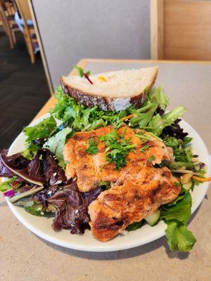 Half Asian salad with salmon and half almond tuna sandwich on sourdough