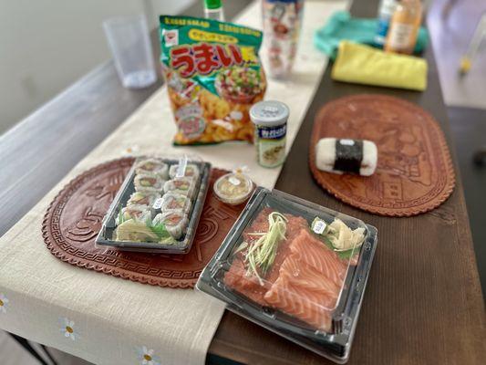 Salmon bento, musibi, furikake seasoning to add, spicy tuna rolls, some Japanese chips, and extra  pickled ginger.