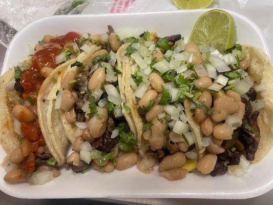 Asada, and Al pastor tacos with beans.