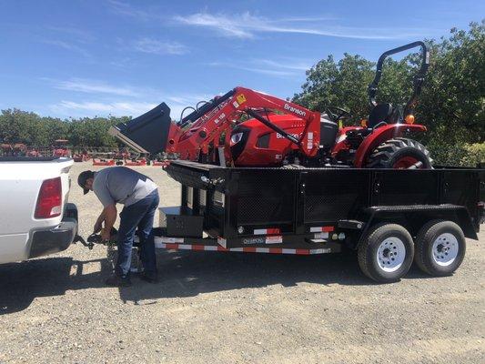 Our tractor, trailer (can't see) auger, post hole digger, mower and pallet forks.