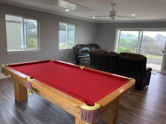 Newley renovated game room with pool table.