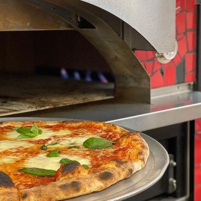 Close up of the House pie and oven at Polizzi's Brick Oven