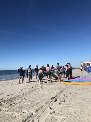 Before hitting the waves, lessons on land, practicing the moves on dry land first.