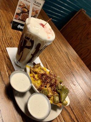 Side of cheddar fries and chocolate shake.