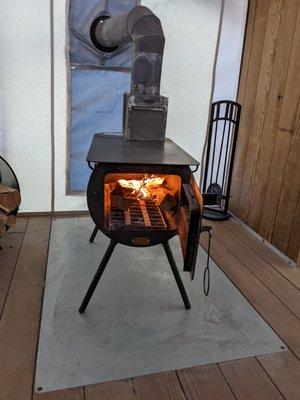 Wood burning stove inside tent.