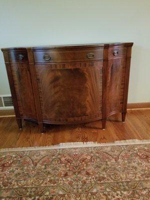 TV lowered into cabinet.