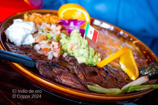 Carne Asada Sliced of Skirt Steak Cooked over Charcoal. Served with Guacamole, Jalapeño & Green Onions.