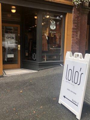 The entrance of lolo's hair design at the good arts building .