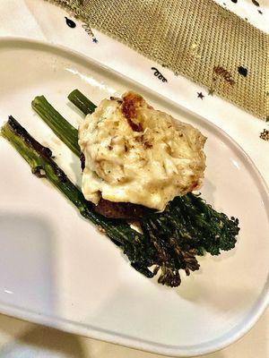 House filet. A petite filet with crab gratin on top served over roasted broccolini.