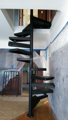 Spiral staircase in Victorian 4-plex, through hardwood floors and coved, lath and plaster ceiling. Turned out perfectly!