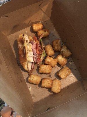 Chicken sandwich with garlic tater tots