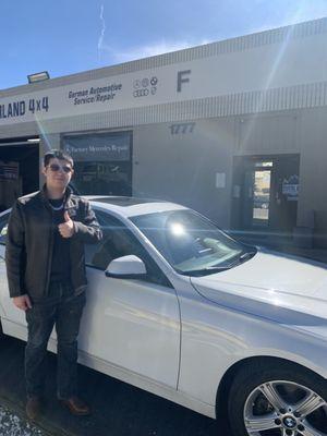 Me and my new car at the BMW repair shop.