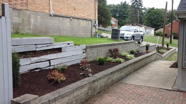 Cleaned out long narrow bed of all weeds and debris.  Installed commercial landscaping fabric and staples...