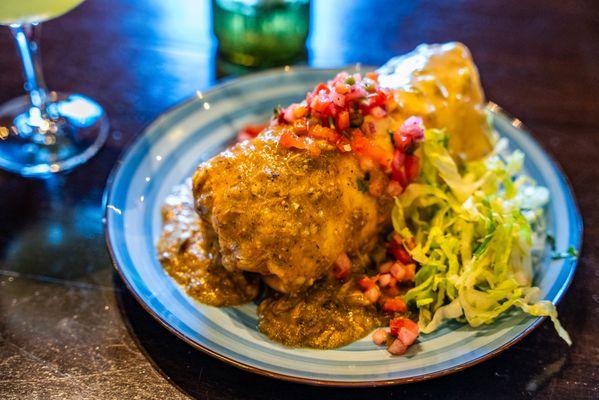 Crispy Stuffed Chimichanga smothered in House Green Chili and White Queso