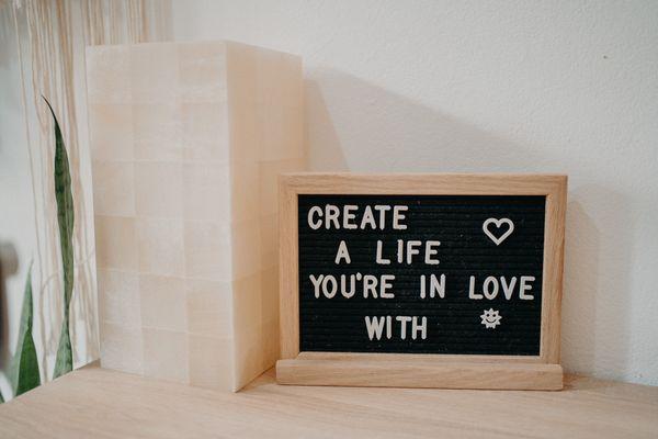 the words "create a life you're in love with" in a frame.