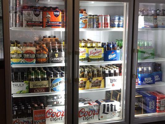 Fully stocked beer cooler with seasonal beers like Sam Adams Oktoberfest, Blue Moon Harvest, Southern Tier Pumpkin, and Travelers Jacko!