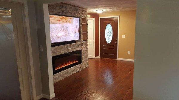 Living room Renovation: Personalized Fireplace, including hardwood floor installation, and freshly painted walls.