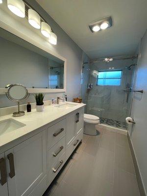 Double vanity, mirror and two single faucets.