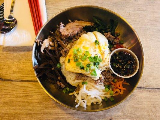 Bibimbap rice bowl topped with fried egg