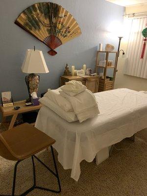 The treatment room with fresh linens.