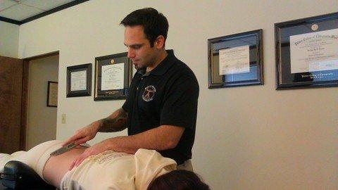 Performing Graston soft tissue work for the low back