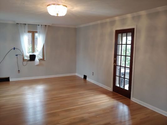 Living room repainted. Baseboard and door casing changed from stained to painted white.