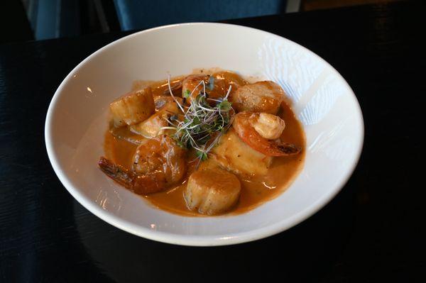 FRUTTI DI MARE RAVIOLI, our housemade lobster-stuffed ravioli, seared sea scallops, jumbo shrimp, lobster Demi cream sauce