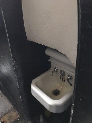 Hand sink embedded in wall to make sure you can make it to the potty