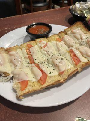 Garlic cheese bread with tomatoes. Needs more garlic. Not very flavorful.