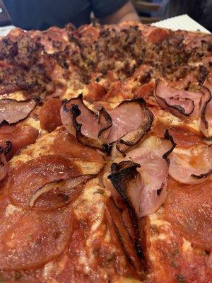 Pepperoni pizza with half sausage half ham