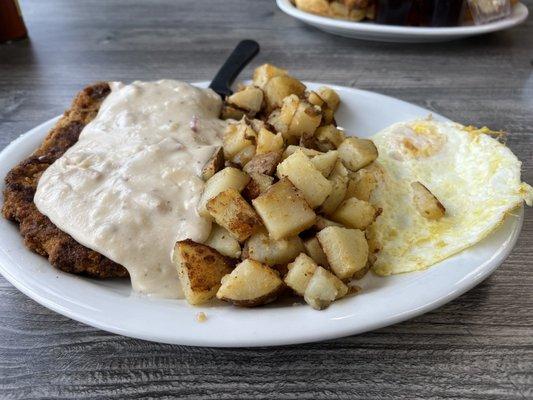 Chicken fried steak with home fries