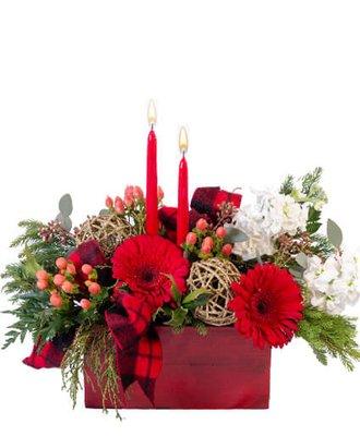 A festive red Christmas centerpiece with candles can create a warm and inviting atmosphere for the holiday season.