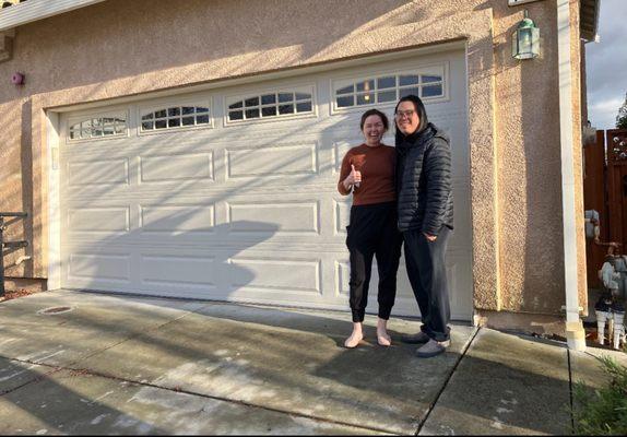 Happy clients with a new garage door installation.