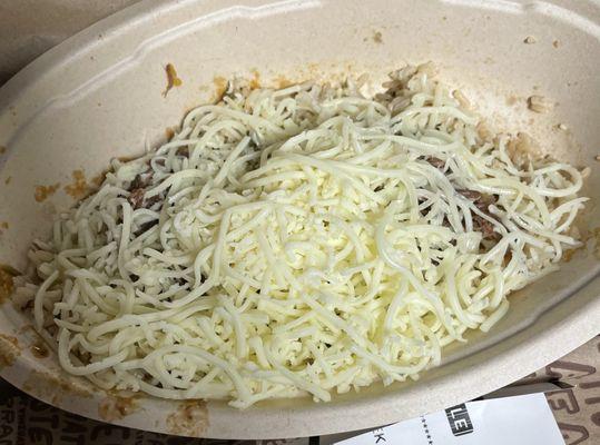 Burrito bowl with white rice, beef barbacoa and a mound of cheese. Not what I ordered and only about 1/2 full.