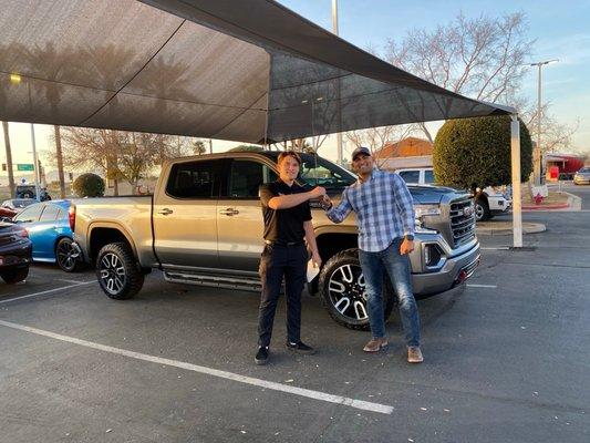 Justus handing me the keys to my 2021 GMC AT4