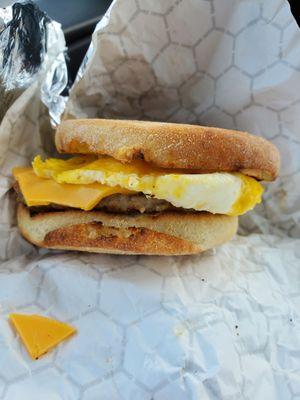 English muffin breakfast with sausage.