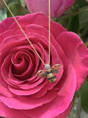 Yellow gold bee pendant with black, brown and white diamonds