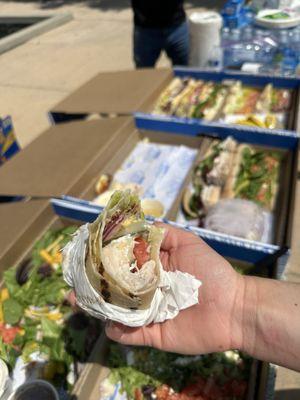 Catering order, 2 boxes of mixed sandwiches, 1 box of salad. Gluten-free wrap in foreground.