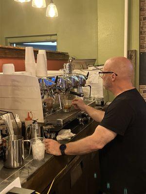 The proprietor making a latte