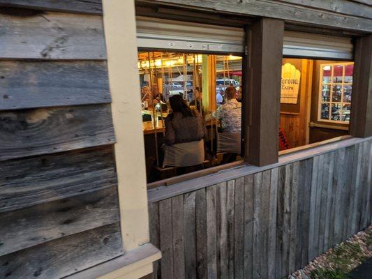 Outside bar and it has swings instead of chairs!