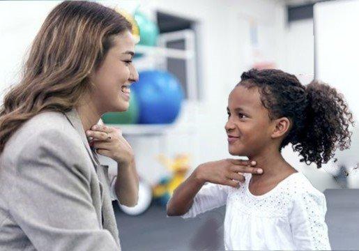 Speech pathologist doing pediatric voice therapy