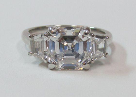 3.01 Carats Asscher Cut Diamond, GIA D color, VS1 clarity, platinum mounting with side trapezoid diamonds.