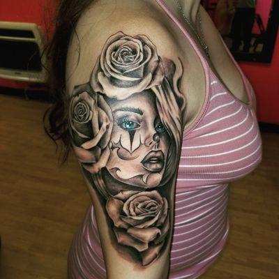 Heres a beautiful womens face with roses around to complement her beauty. Work done by YAYO