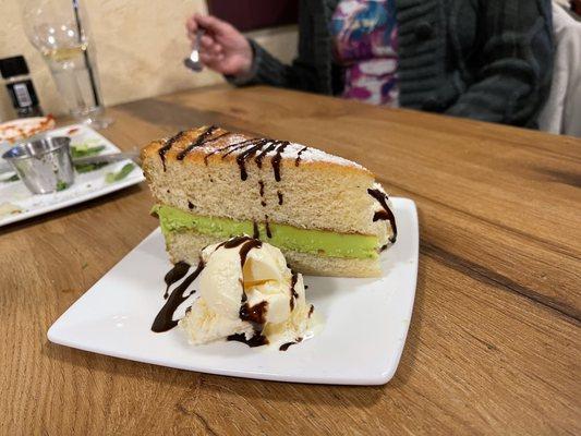 Pistachio cake, another small scoop of ice cream on the other side.