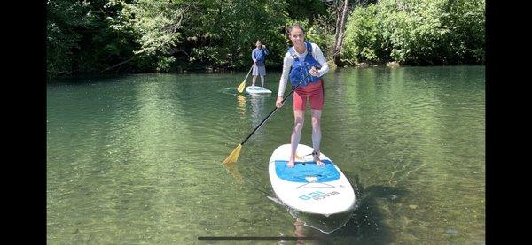 A couple stand up paddleboarding near Hood River, Oregon.