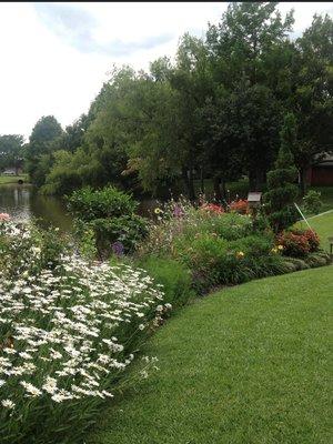 Cottage style garden overlooking a pond.