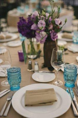 We rented blue water glasses for our wedding and they made the tables extra colorful!